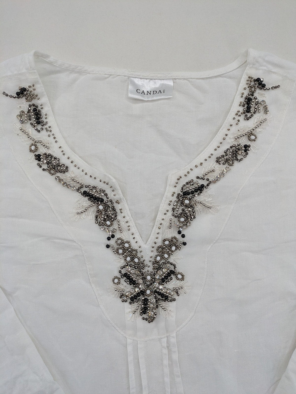 Canda white tunic top with embroidered V-neck, pearl and sequin details, 3/4 sleeves.