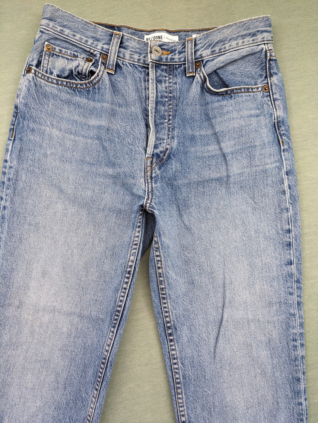 Re/Done blue straight jeans high rise with button fly and raw hem detail.
