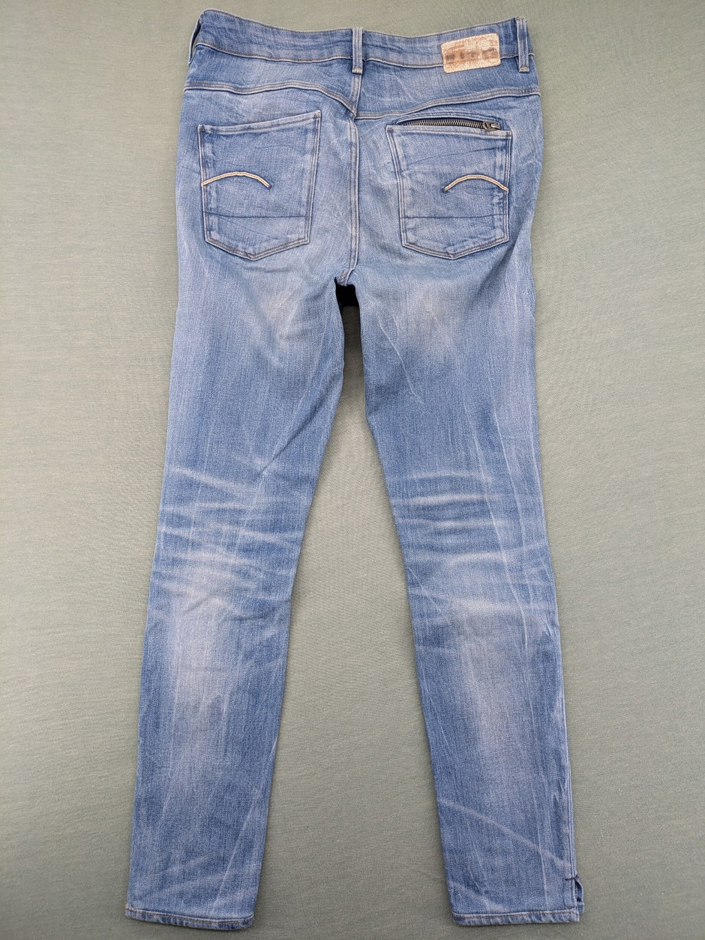 G-Star Raw blue slim skinny jeans with light wash and signature back zip pocket.