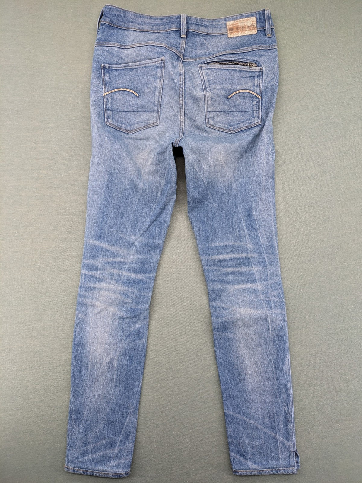 G-Star Raw blue slim skinny jeans with light wash and signature back zip pocket.