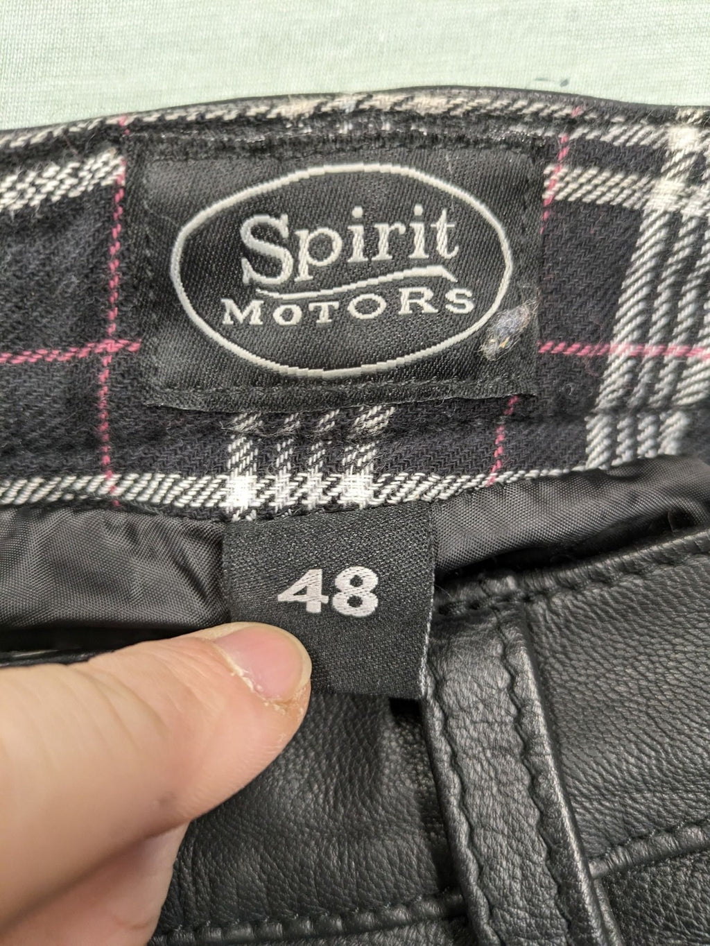 Spirit Motors black leather chaps with red and white accents, 5-pocket style, reinforced knees.