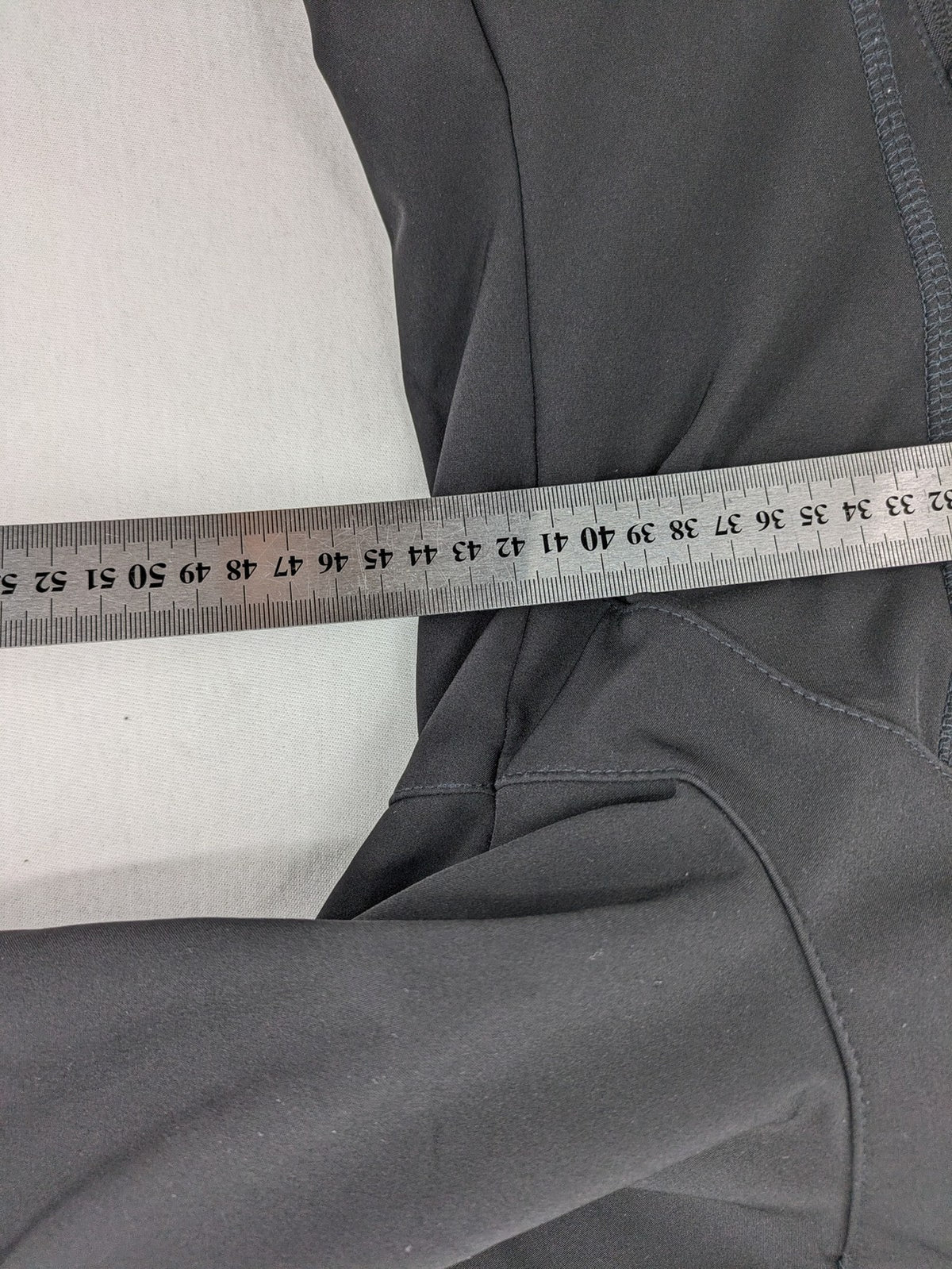 Icepeak black softshell jacket with fleece lining, adjustable hood, and zippered pockets.