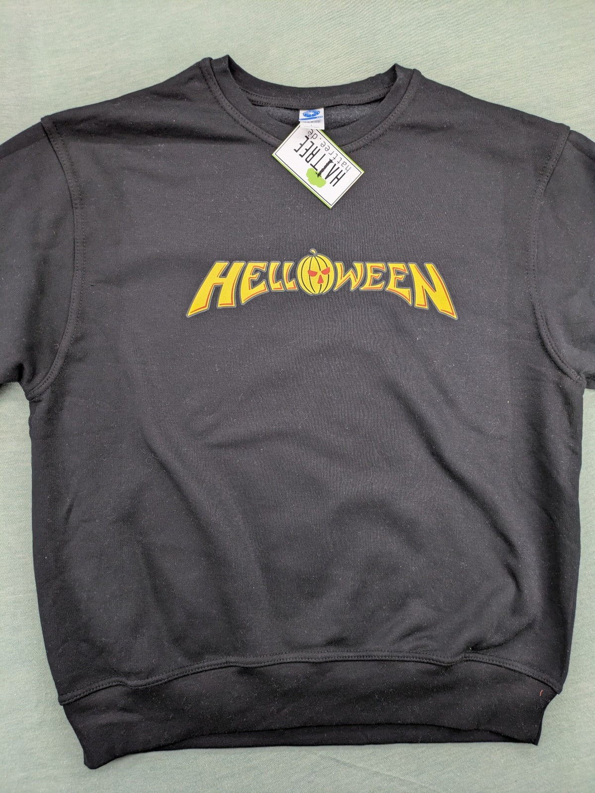 Helloween grey sweatshirt featuring bright yellow pumpkin logo, made from cotton blend.