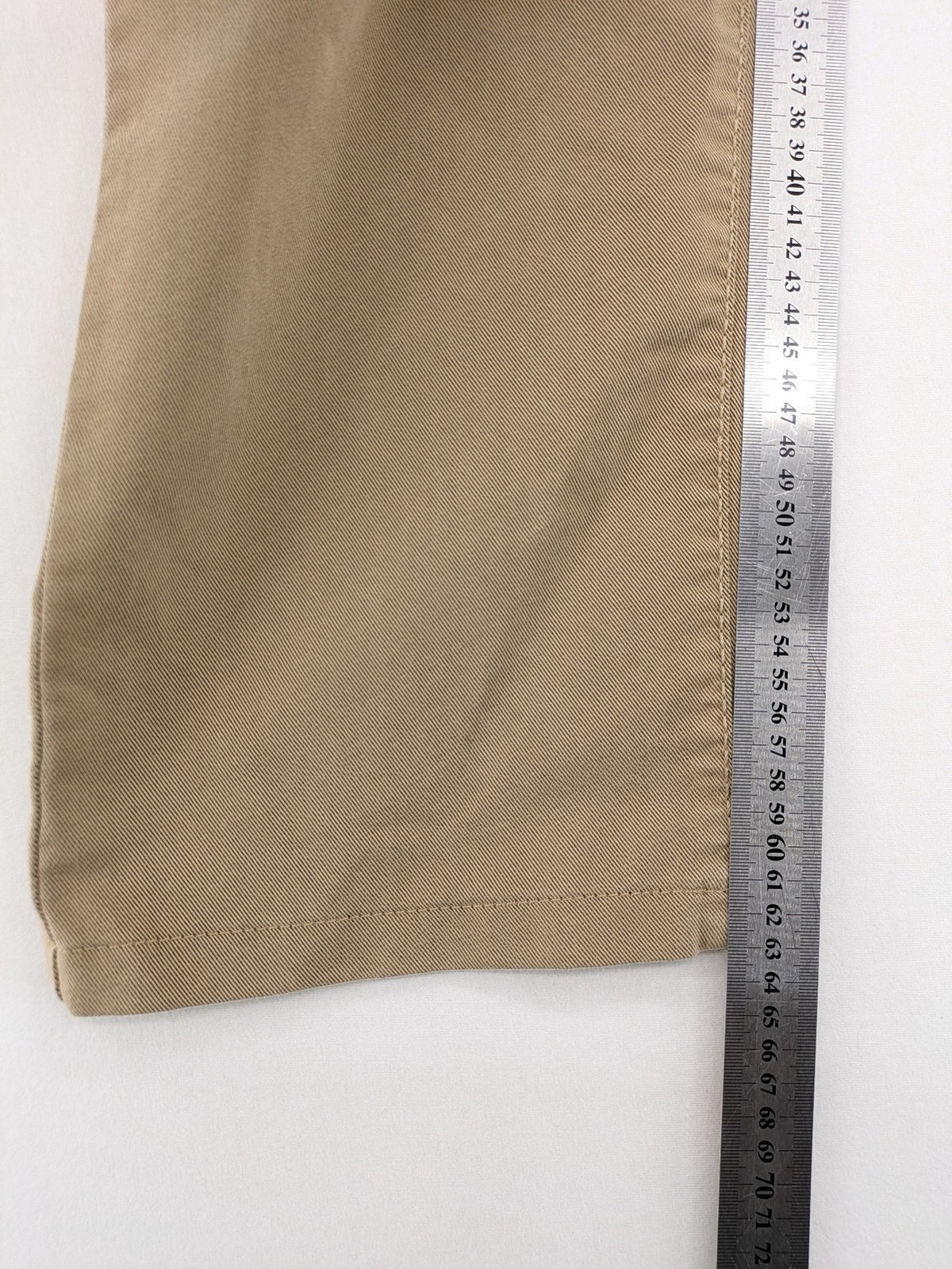 Joker beige straight jeans with double saddle stitching and classic 5-pocket design.