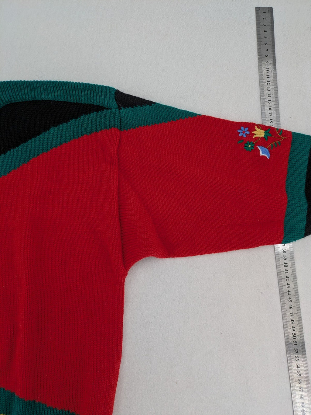 Pullover multi knit jumper featuring colorful block pattern and embroidered rooster and flowers.