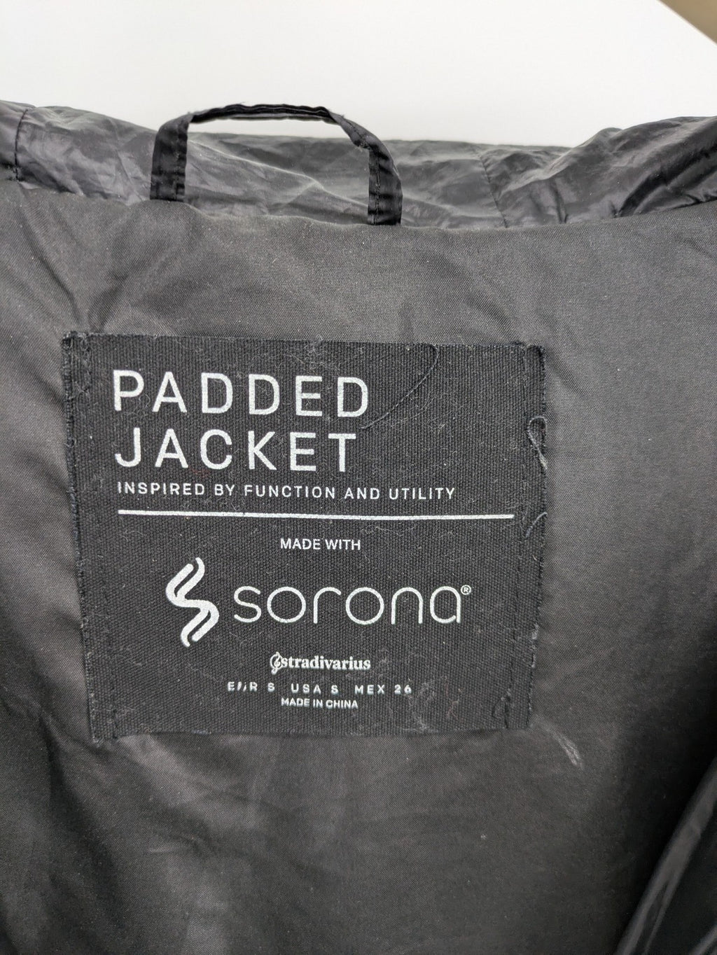 Stradivarius grey coat with chevron quilted pattern and hood, featuring zip closure and snap storm flap.