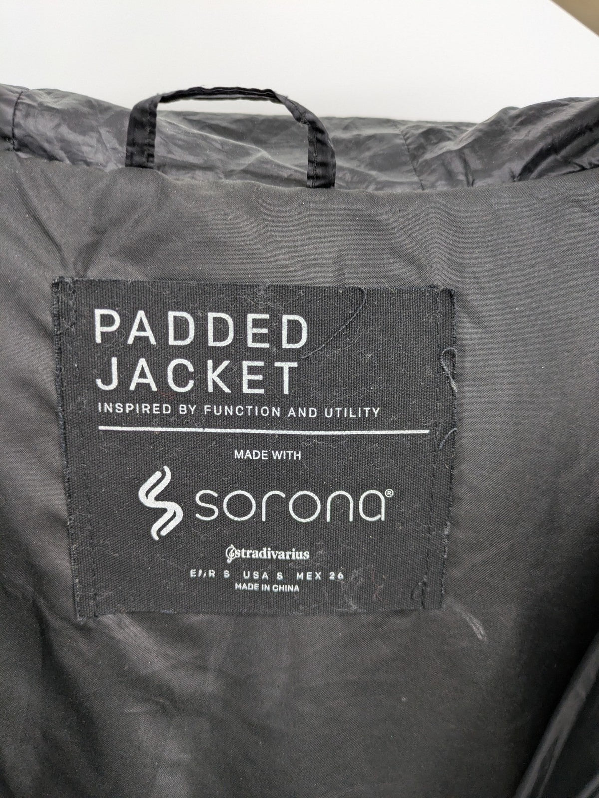 Stradivarius grey coat with chevron quilted pattern and hood, featuring zip closure and snap storm flap.