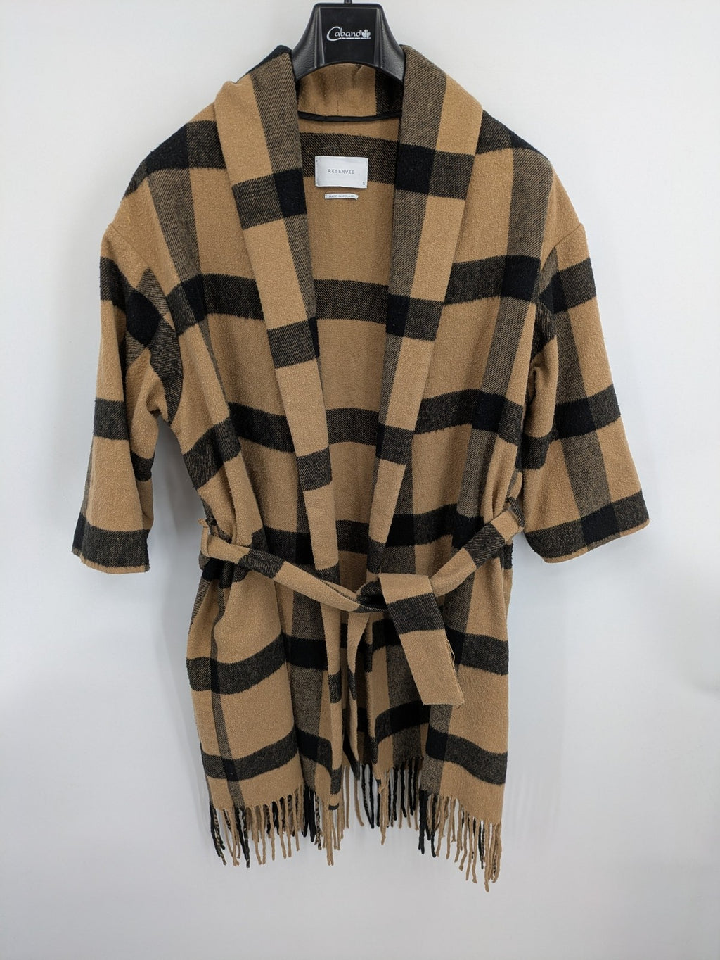 Reserved cream coat with brown and black check pattern, fringe hem, wool blend material.