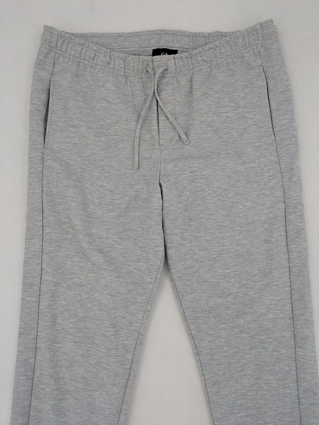 C&A grey sweatpants with elastic waistband, adjustable drawstring, and side pockets.