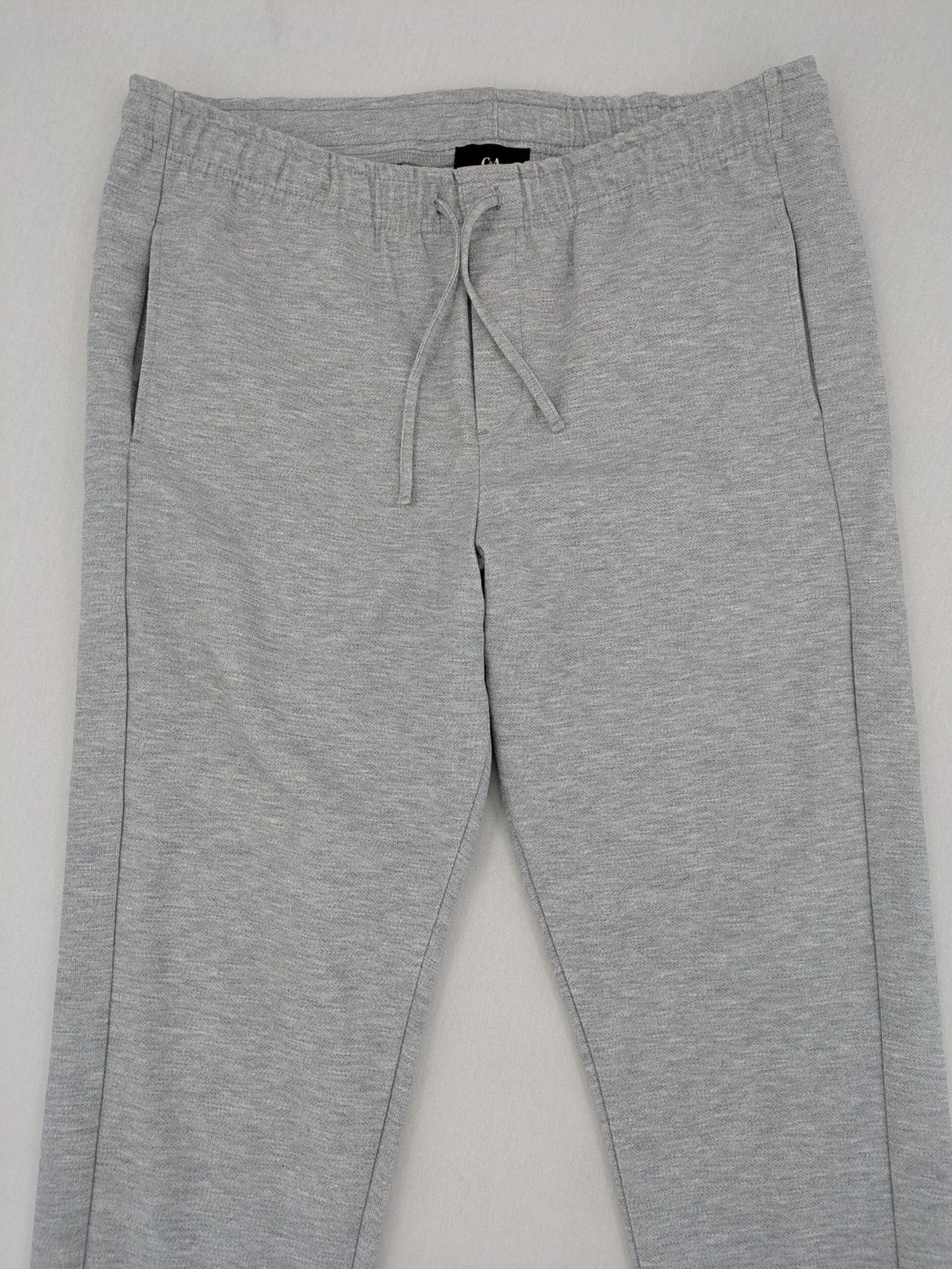 C&A grey sweatpants with elastic waistband, adjustable drawstring, and side pockets.