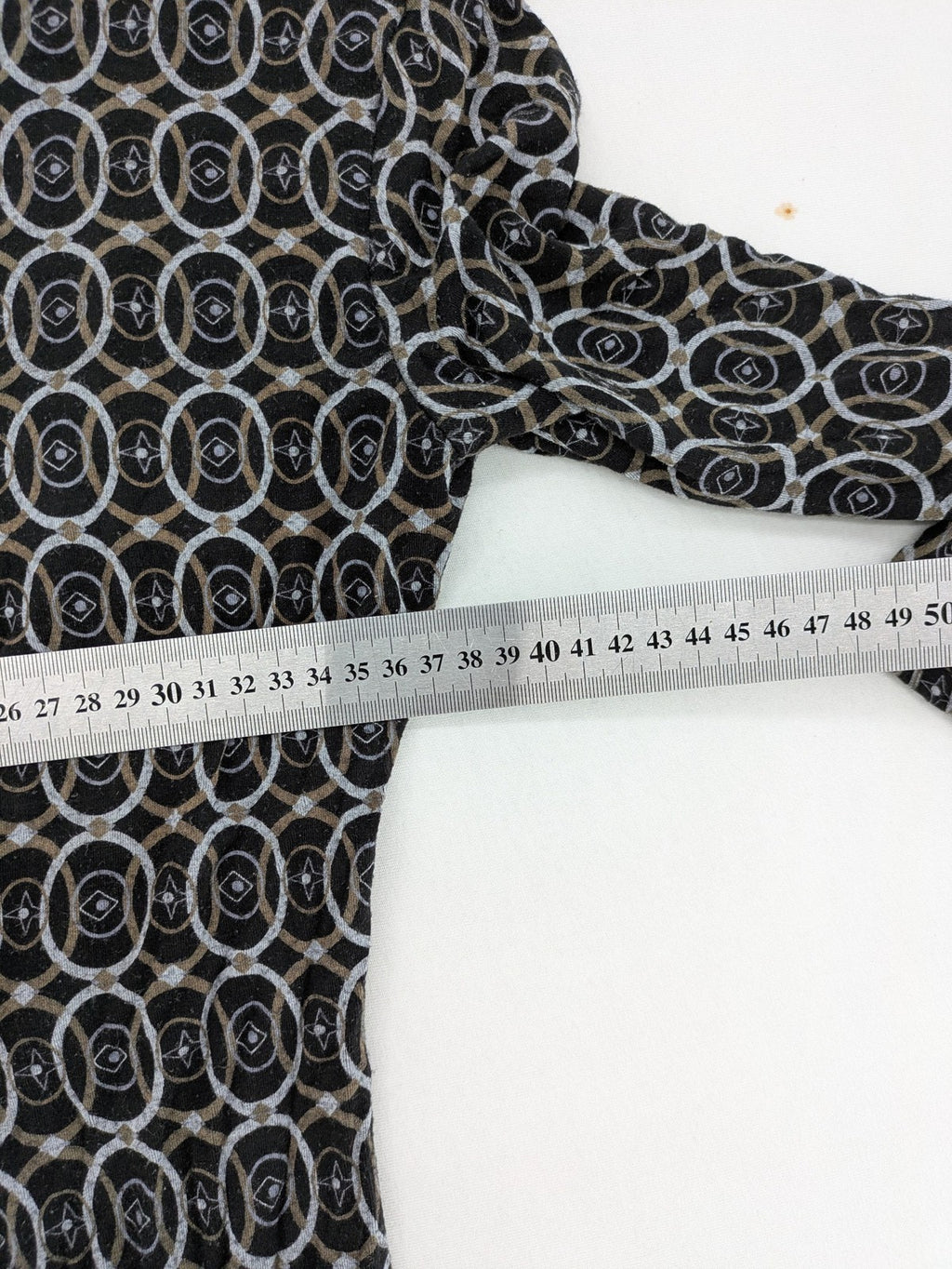 TCM pink wrap dress with V-neck, 3/4 sleeves, geometric black, white, and brown pattern.