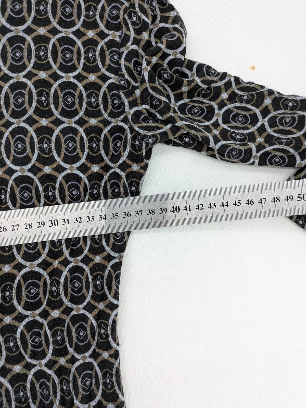 TCM pink wrap dress with V-neck, 3/4 sleeves, geometric black, white, and brown pattern.