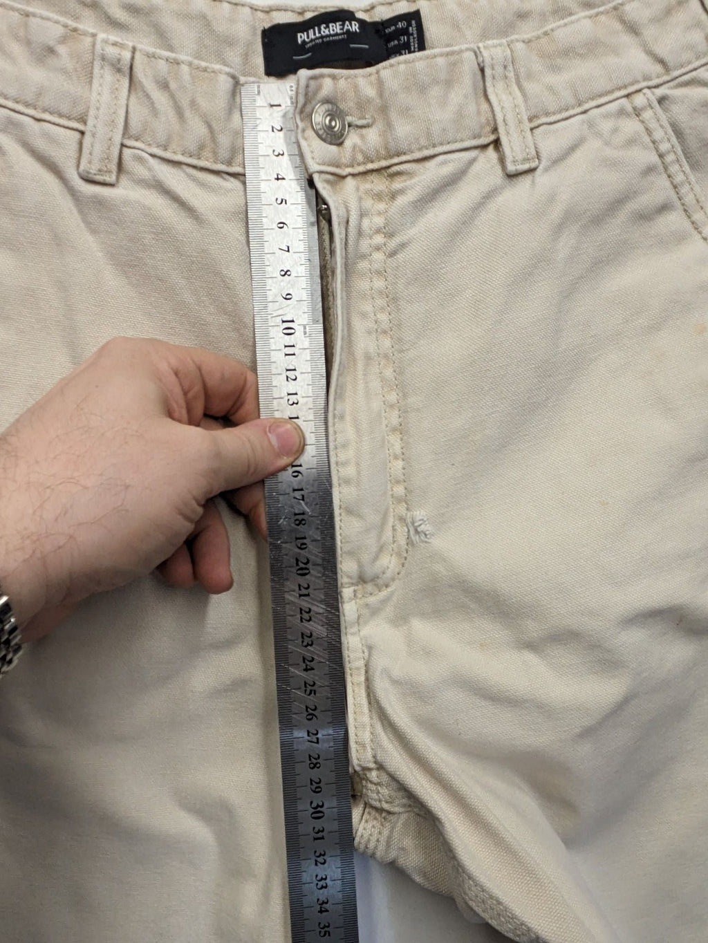 Pull&Bear beige carpenter pants with classic zipper, belt loops, and durable cotton material.