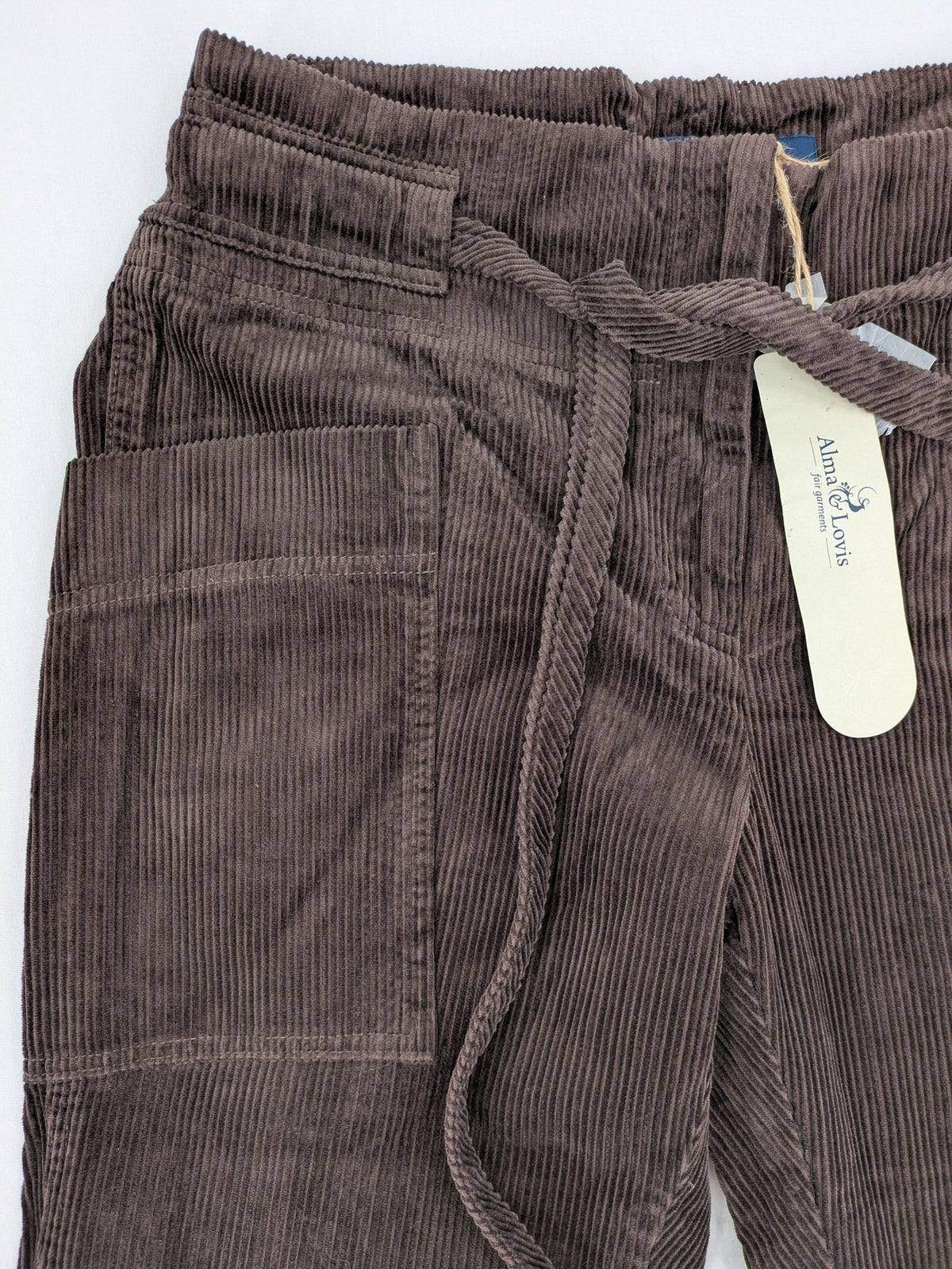 Alma & Lovis brown cord pants with elastic waistband, drawstring, and front patch pockets.