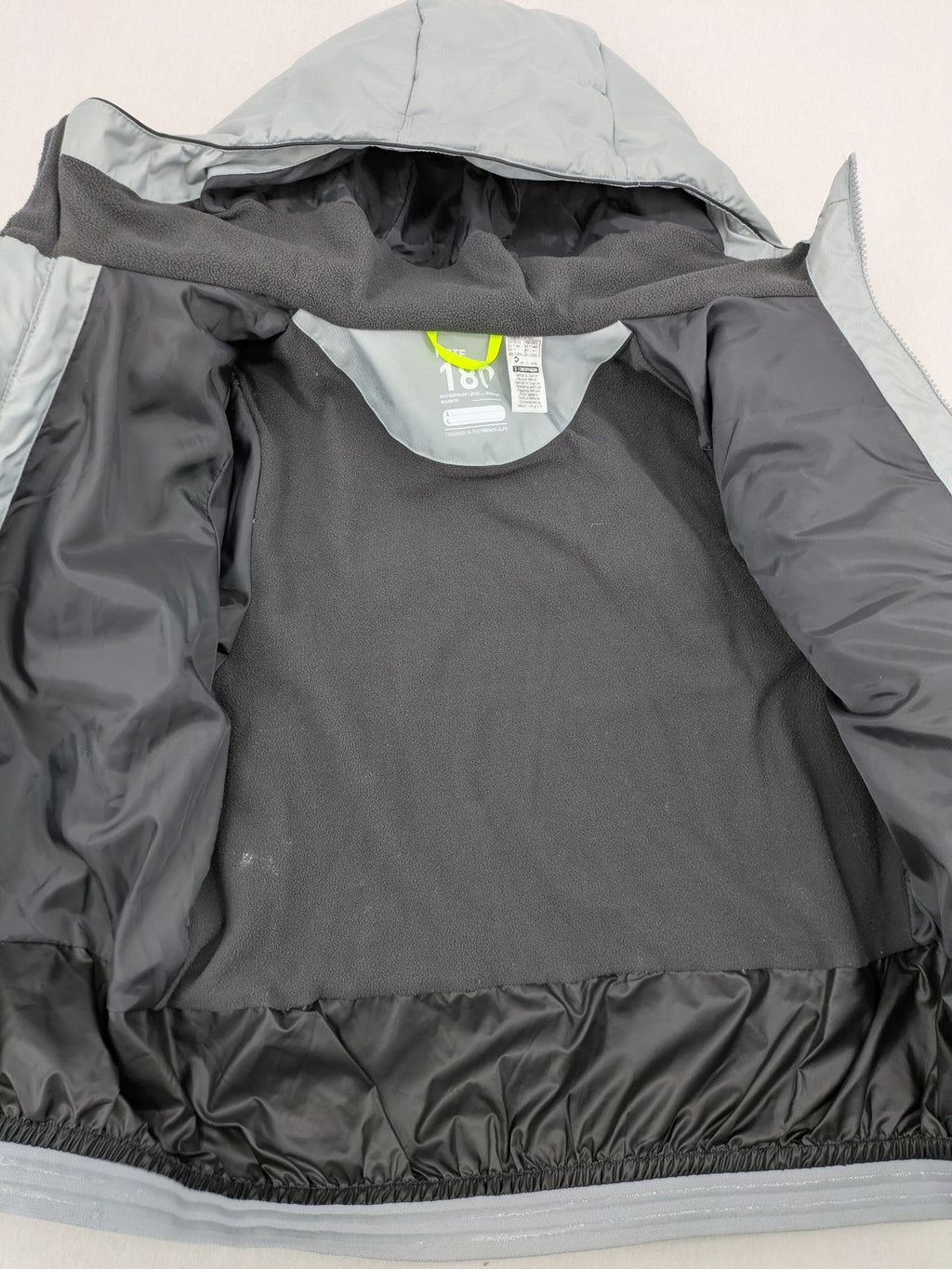 Wedze ski coat grey and black colorblock design with neon accents and fleece lining.