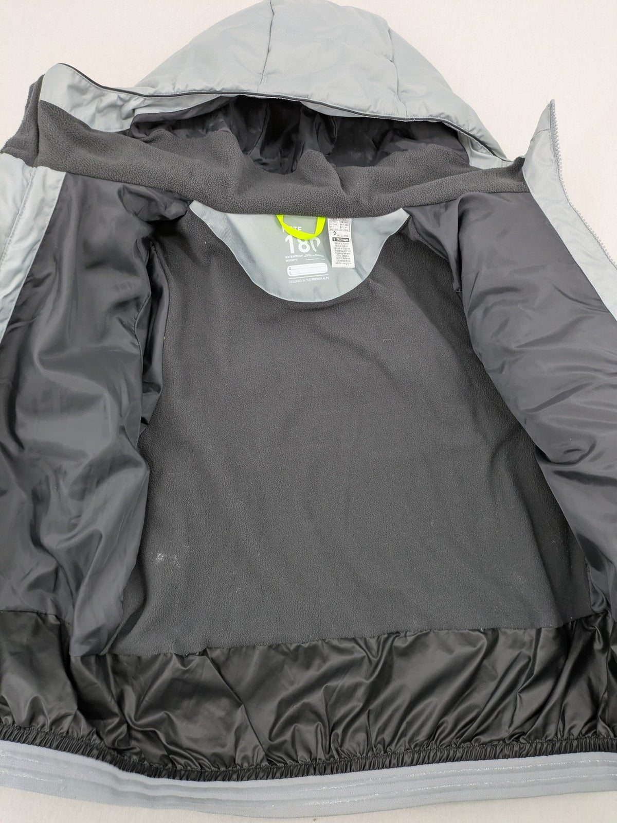Wedze ski coat grey and black colorblock design with neon accents and fleece lining.