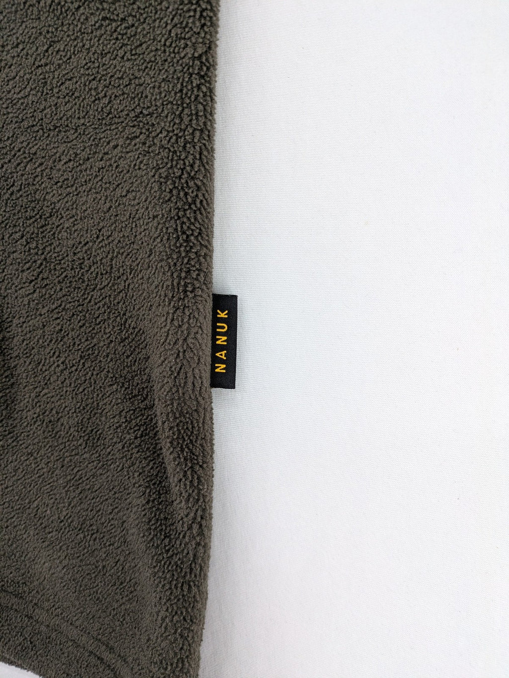 Jack Wolfskin khaki turtle neck jumper with quarter zip and embroidered paw logo.