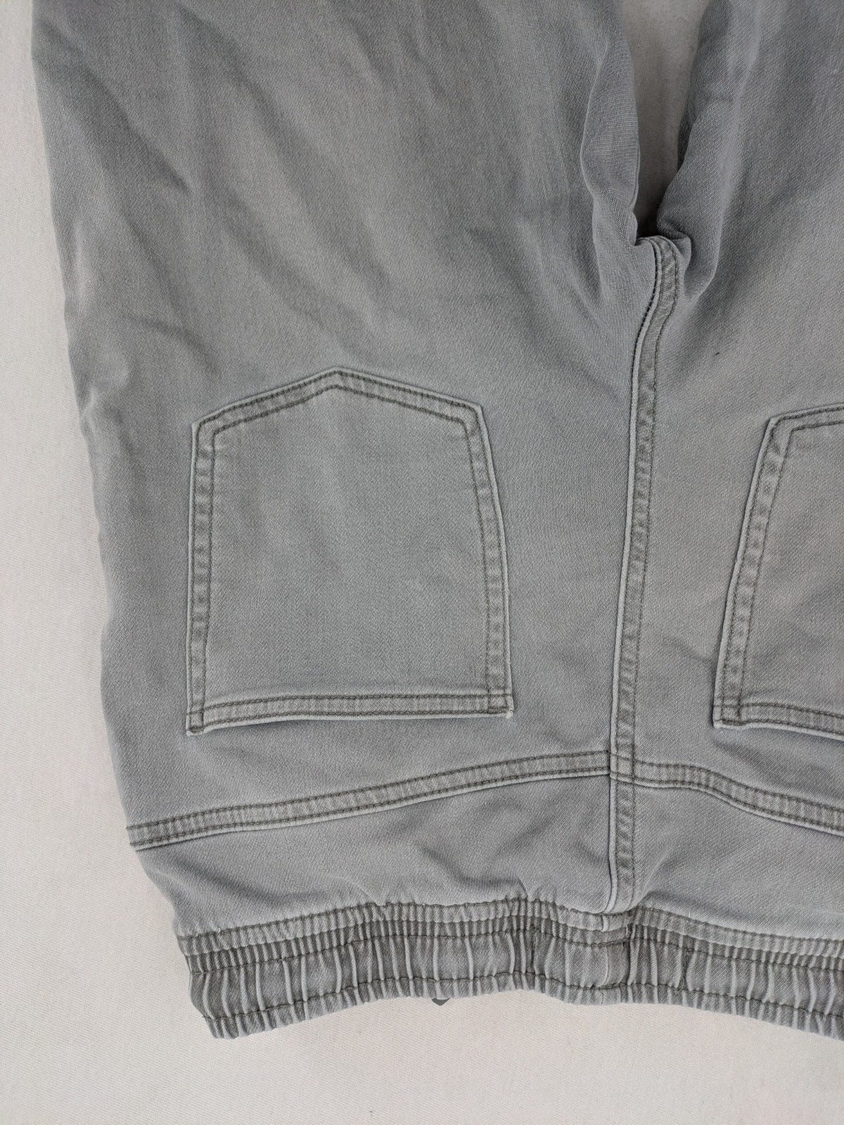 Denim & Co. grey jogger jeans with elastic waistband and ankle cuffs, cotton material.