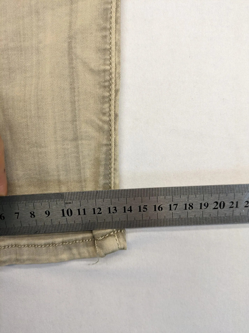 Mozaar beige straight jeans with unique asymmetrical button placket and practical pockets.