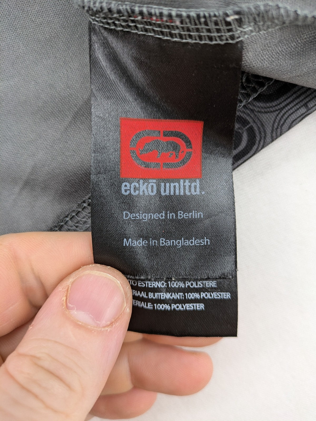 Ecko Unltd. grey soccer uniform V-neck with all-over logo print and embroidered FC patch.
