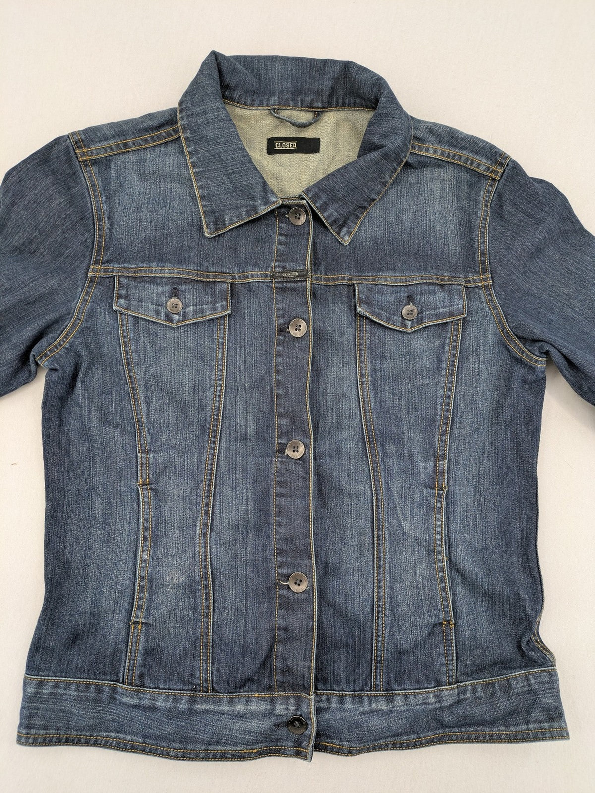 CLOSED blue denim trucker jacket with button front and two chest pockets.