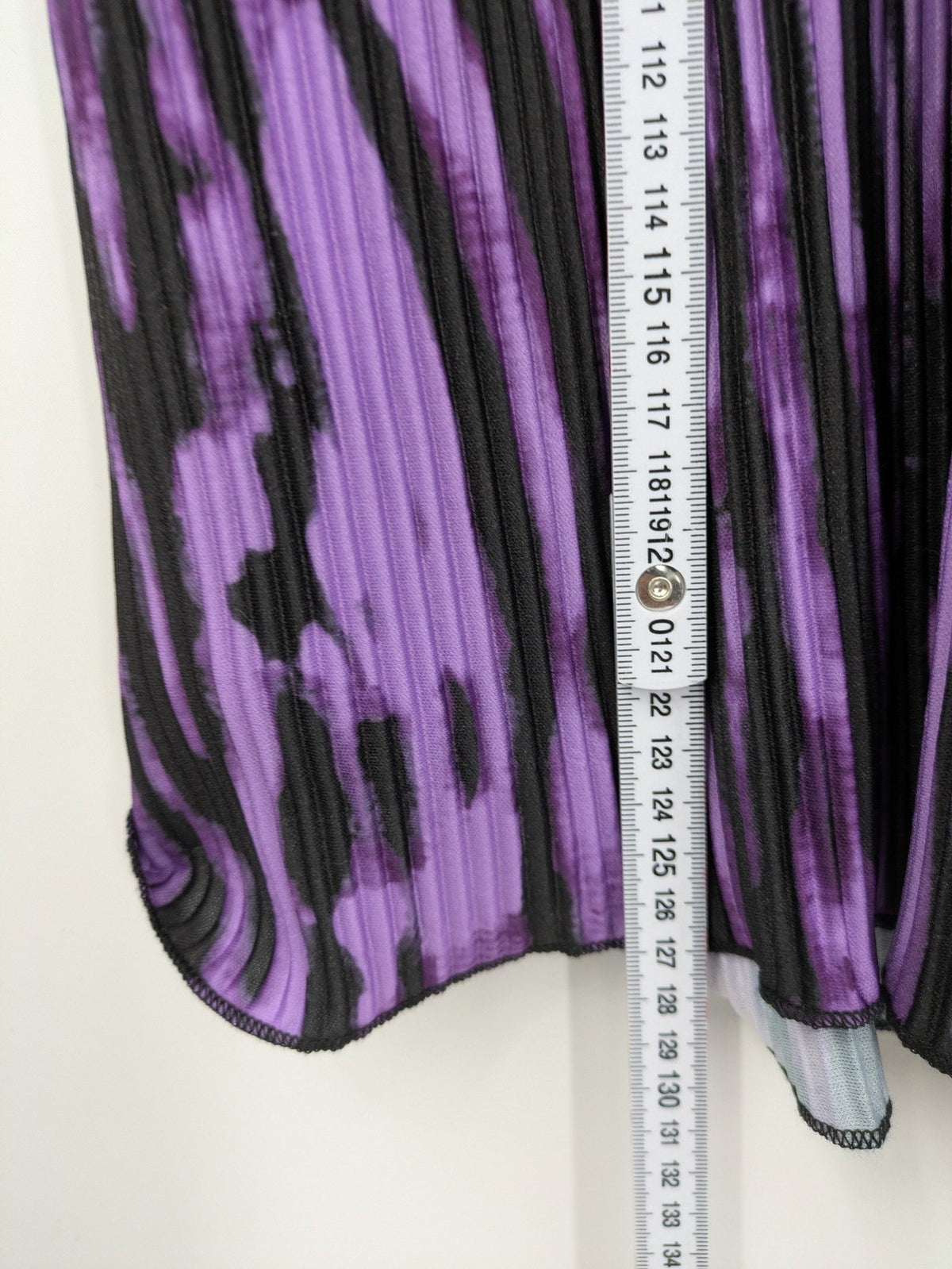Untold black and purple pleated dress with animal print pattern and long sleeves.