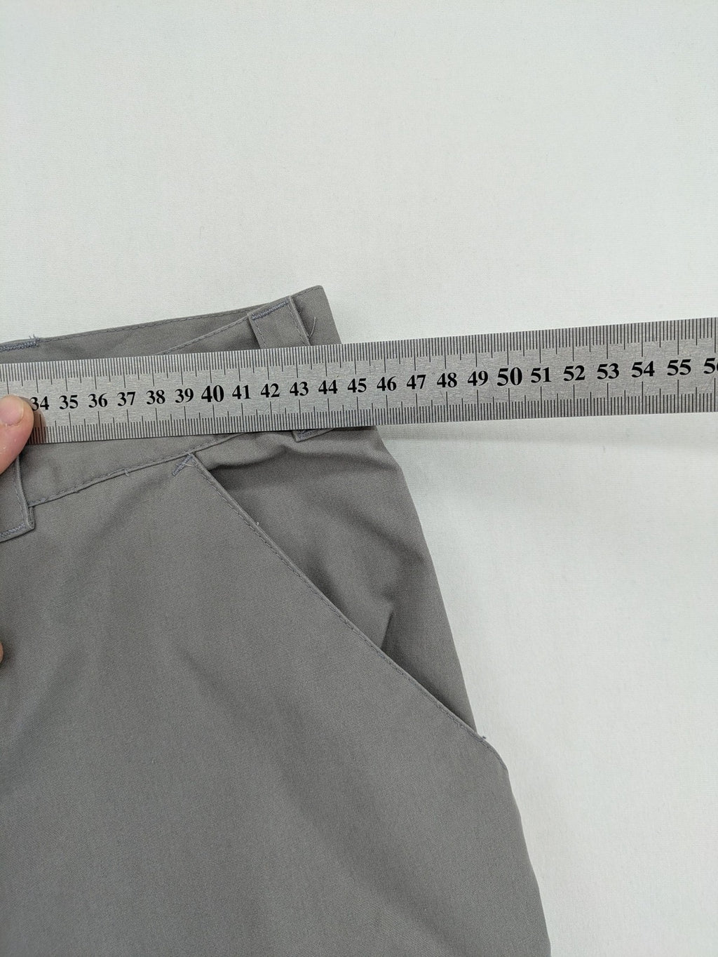 YETI grey cargo pants with multiple zippered pockets and durable material.