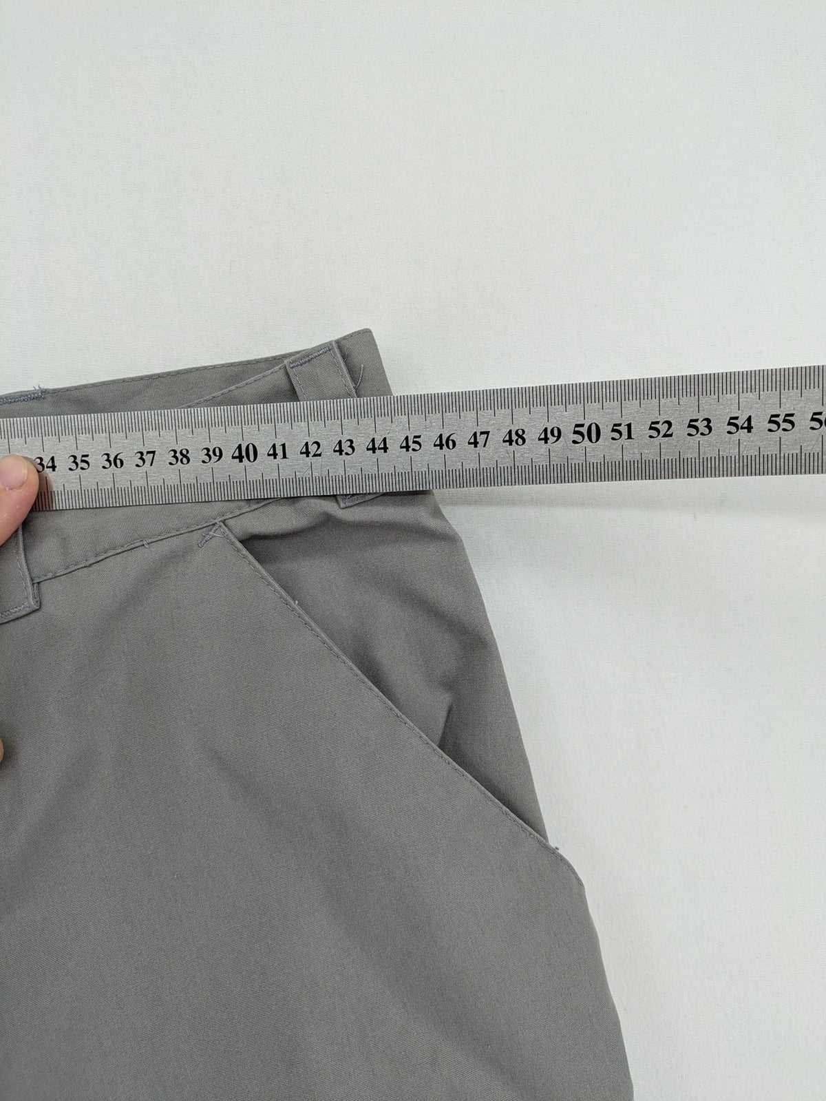 YETI grey cargo pants with multiple zippered pockets and durable material.