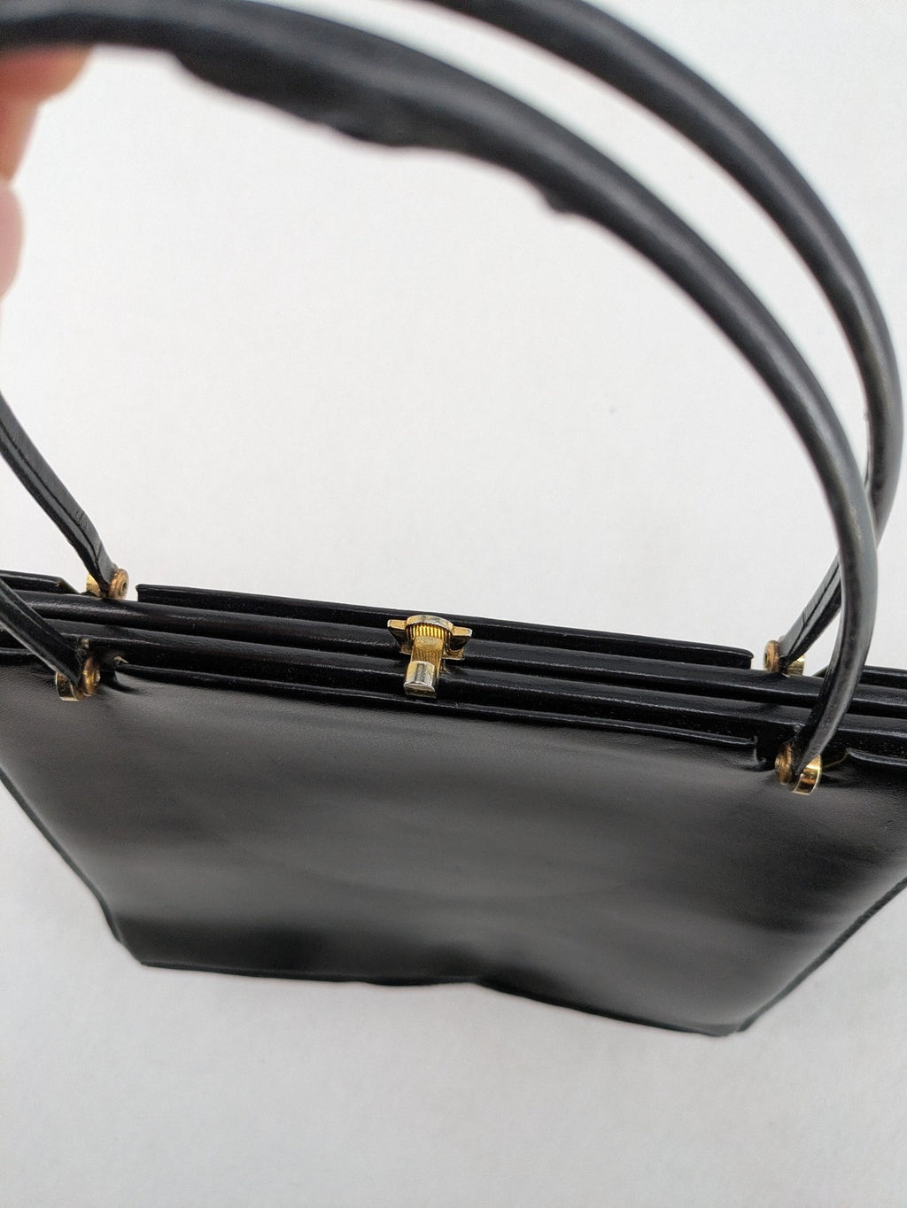 Eleganz black messenger bag vintage 50s 60s style with structured shape and gold accents.