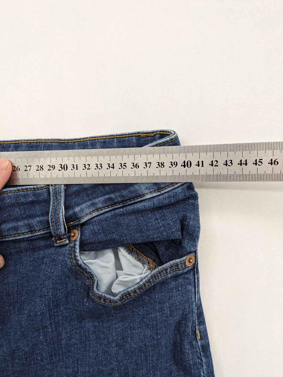 H&M blue skinny jeans with stretch denim and slim fit design.