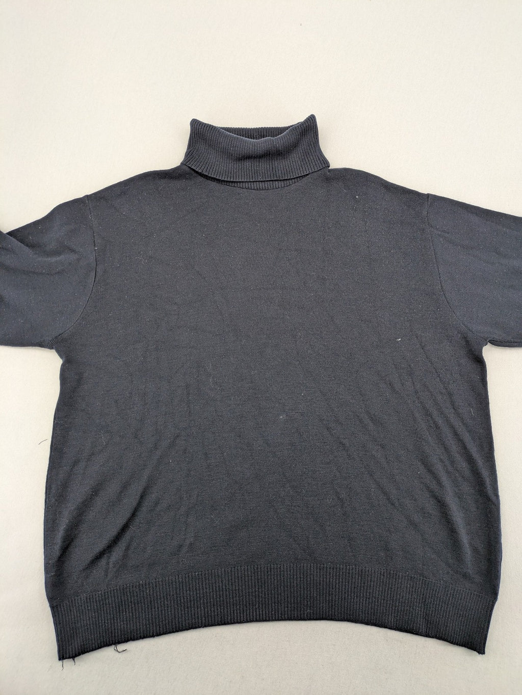 Dinovo grey knit jumper with ribbed roll neck and cuffs, made from merino wool blend.