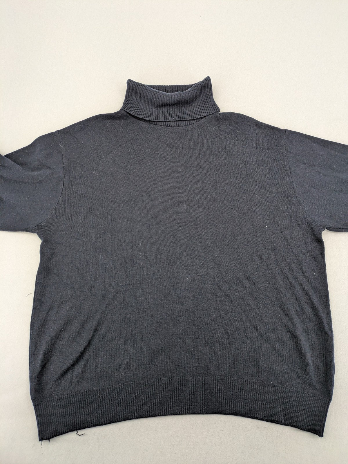 Dinovo grey knit jumper with ribbed roll neck and cuffs, made from merino wool blend.
