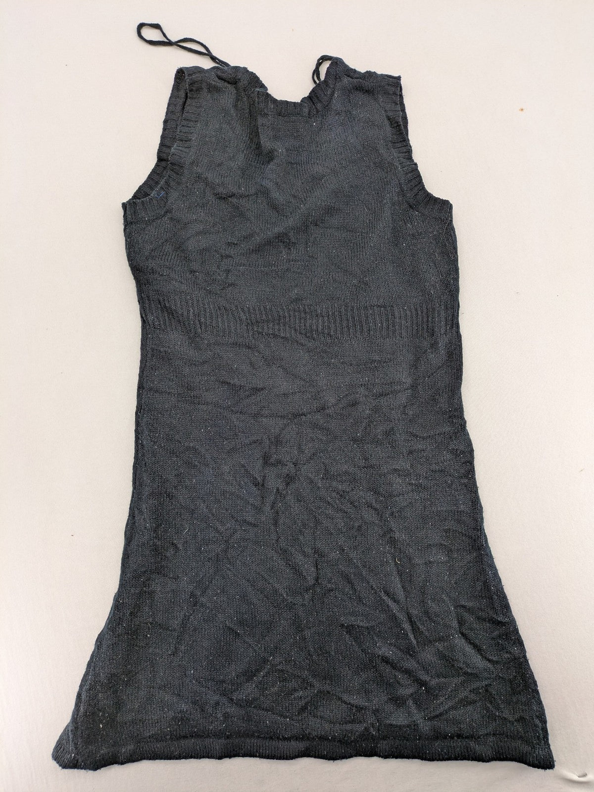 Okay black sleeveless dress V-neck with decorative cord and cable knit pattern.