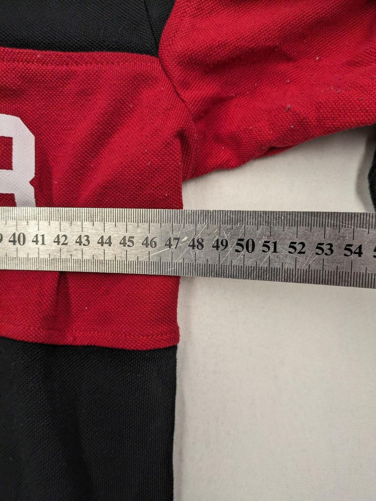 Huge Fashion Exchange rugby polo shirt red and black striped with "SUPERB" graphic.