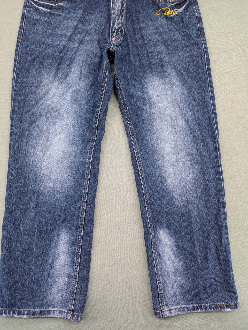 Y2K blue straight jeans with colorful logo embroidery and baggy fit.