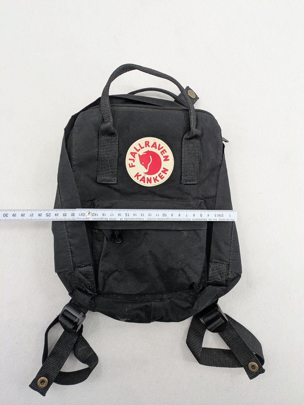 Fjällräven Kånken Mini rucksack black durable fabric with logo and zippered main compartment.