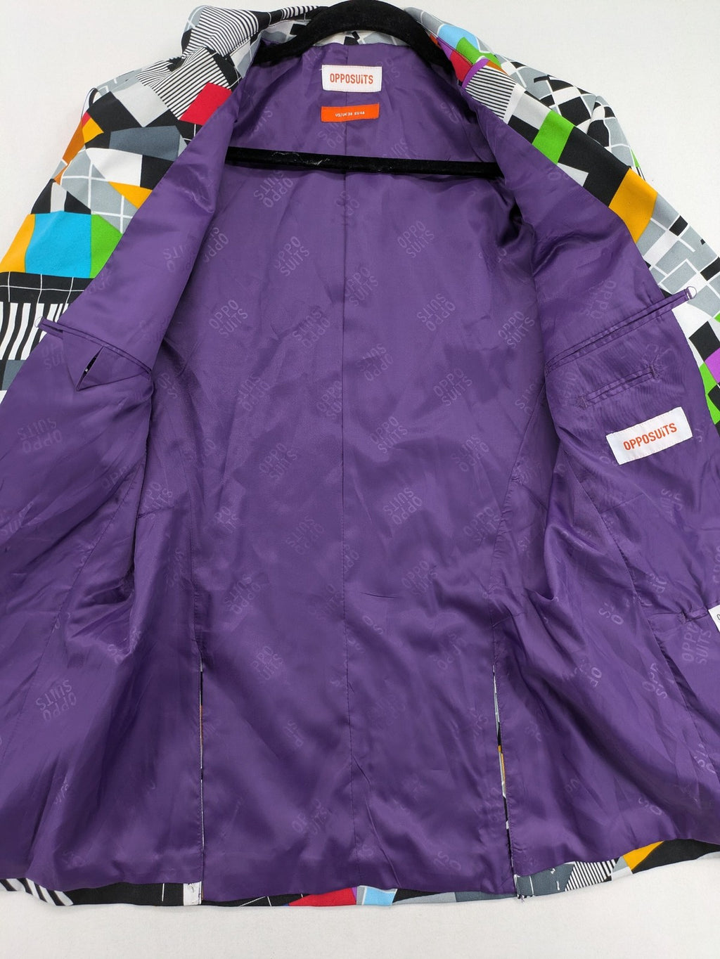 Opposuits blue and green blazer with vibrant geometric pattern and purple satin lining.