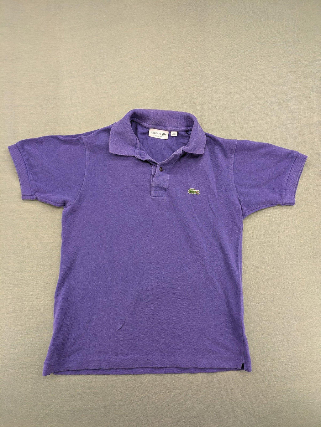 Lacoste purple polo shirt classic fit with embroidered crocodile logo and short sleeves.