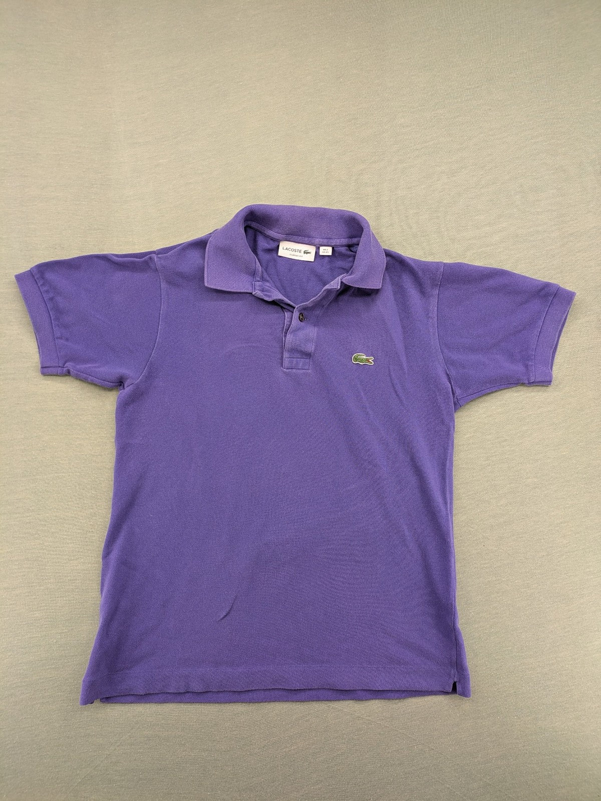 Lacoste purple polo shirt classic fit with embroidered crocodile logo and short sleeves.