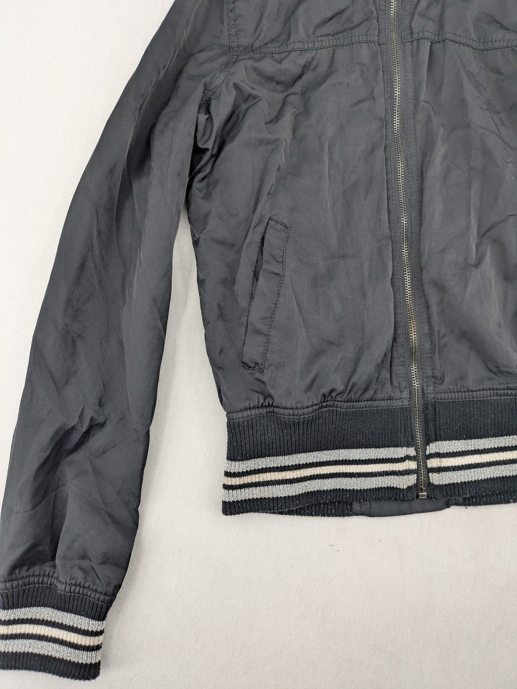 Ann Christine black bomber jacket with striped ribbed collar and cuffs, zip closure.