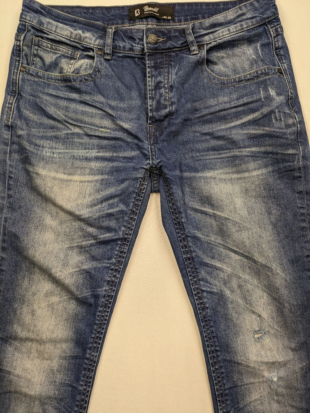 Brandit blue straight jeans with distressed details, button fly, and classic 5-pocket style.
