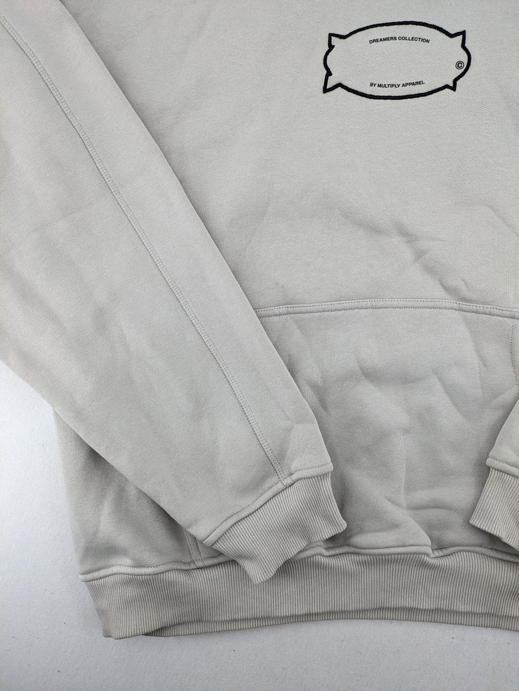 Multiply grey zip-through hoodie with embroidered logo and large "MLTPLY" print on back.