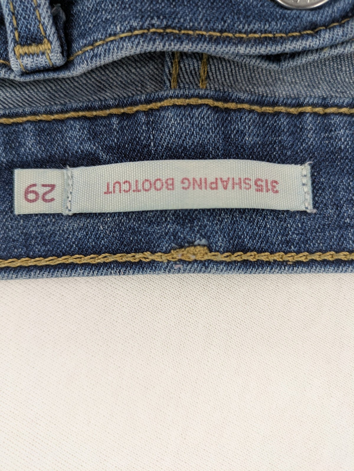 Levi's blue denim Bermuda shorts with rolled cuffs and classic 5-pocket design.