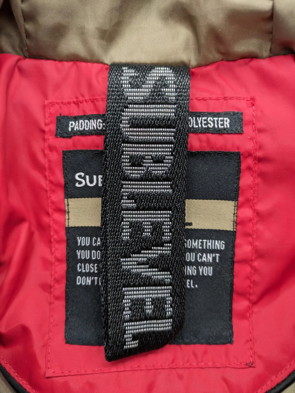 Sublevel red puffer jacket size S, chevron quilted pattern, adjustable hood, recycled polyester lining.