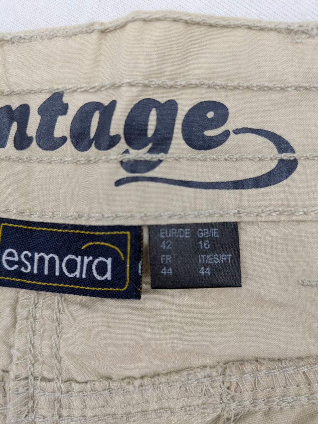 ESMARA beige cargo mini skirt with utility pockets and classic zipper button closure.