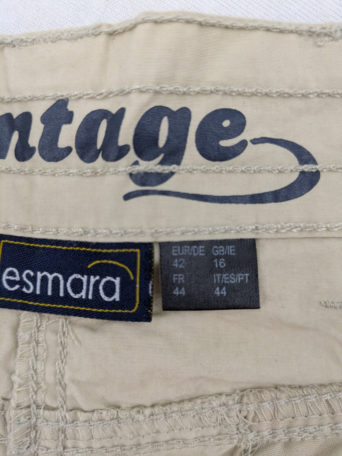 ESMARA beige cargo mini skirt with utility pockets and classic zipper button closure.