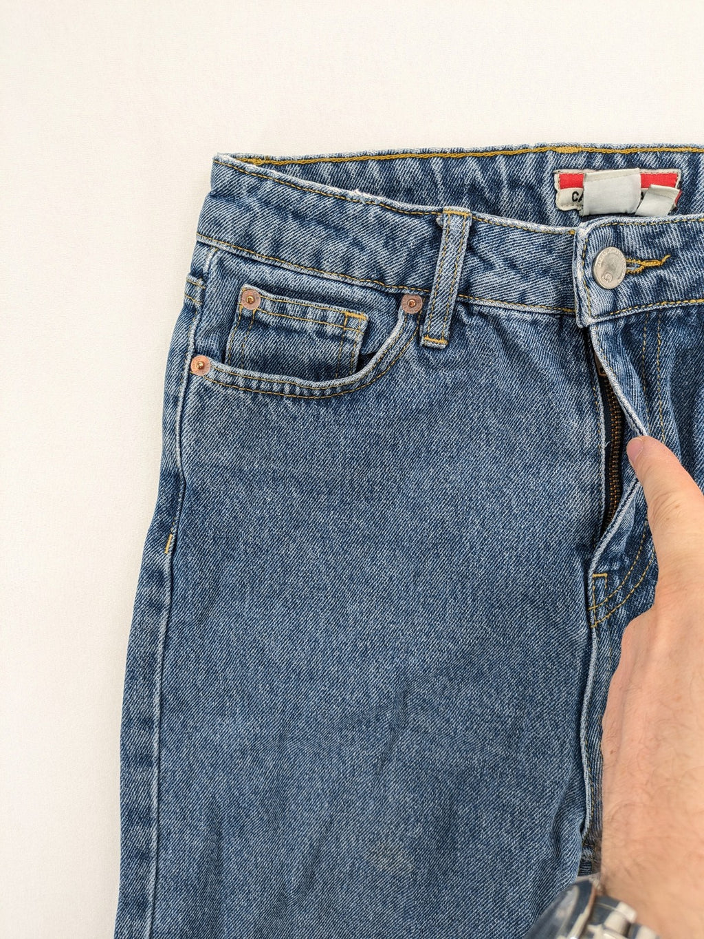 Castro Jeans blue straight leg jeans high waist with white paint splatter details.
