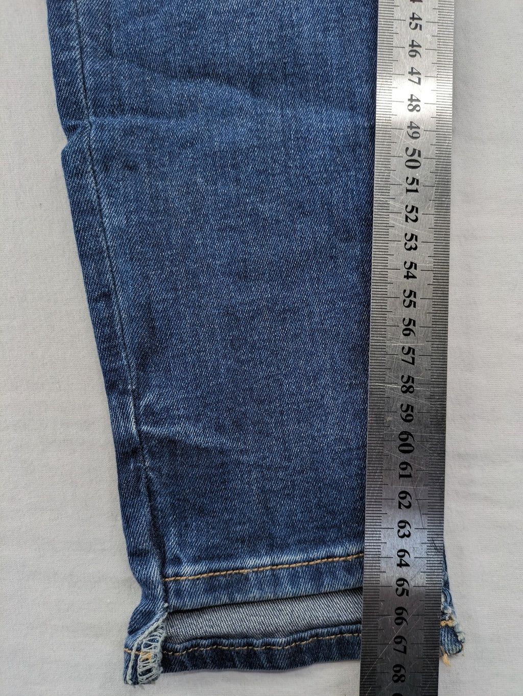 Zara Basic blue skinny jeans with destroyed knee details and frayed hem.