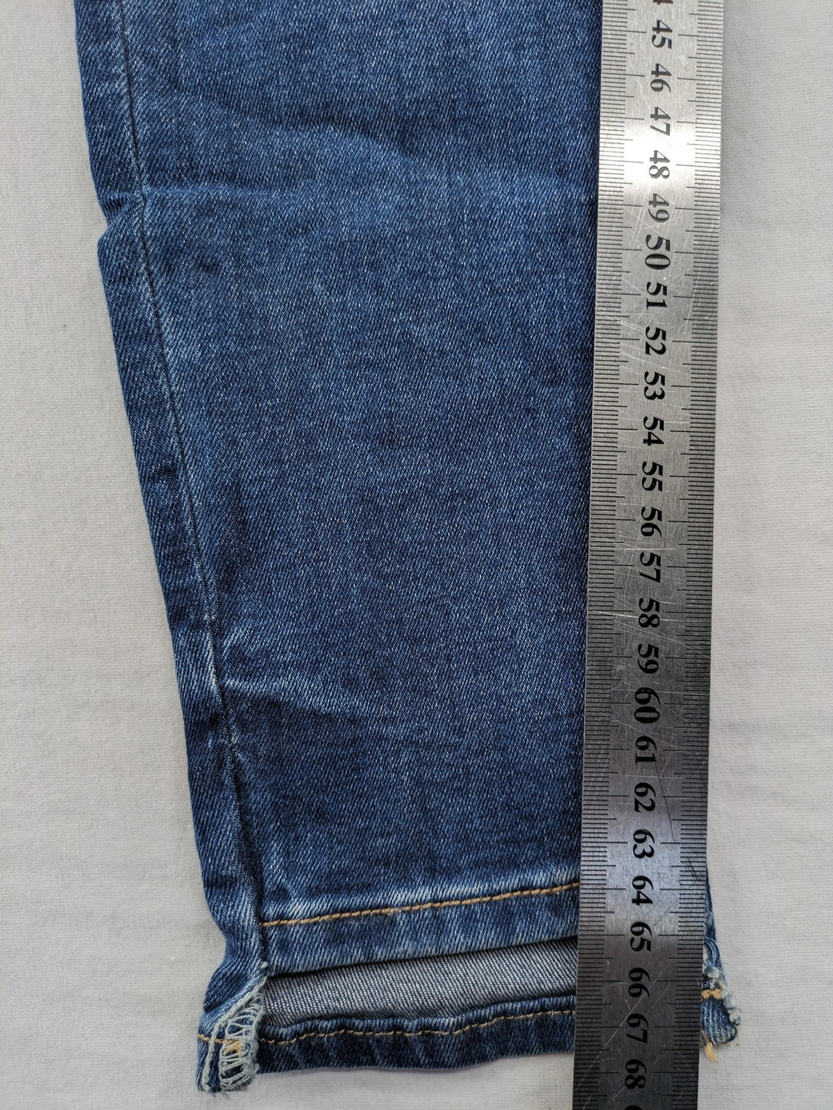 Zara Basic blue skinny jeans with destroyed knee details and frayed hem.