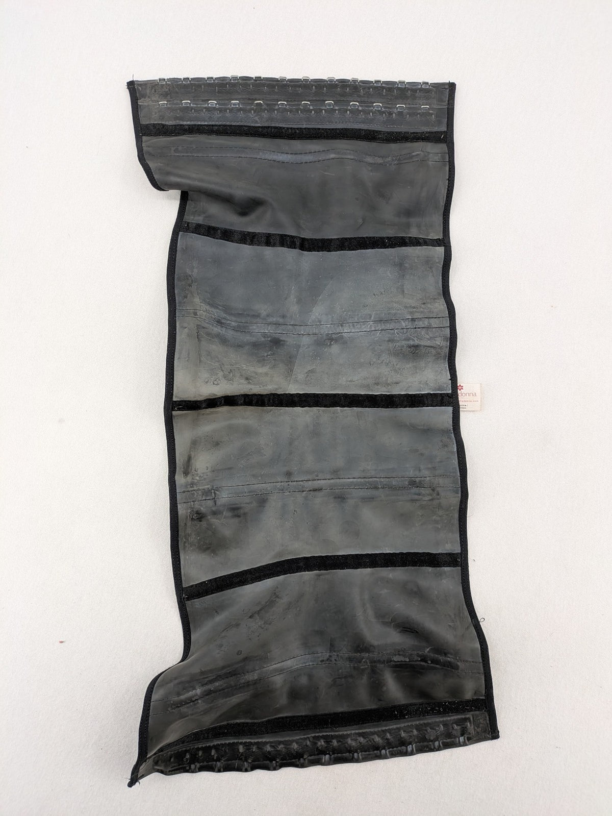 Faja black shapewear body shaper with multiple hook-and-eye closures and latex core.
